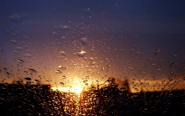 Sunset through a rain-streaked window