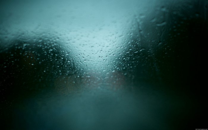 Raindrops on glass with blurred background