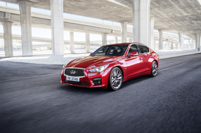 Red Infiniti Q50S 3.0t driving under overpasses