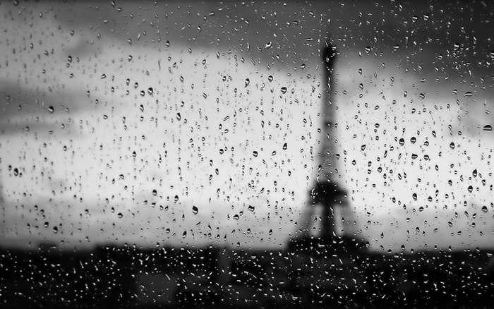 Raindrops on glass with Eiffel Tower in background