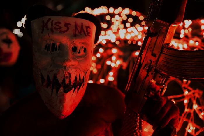 Masked figure with gun in The Purge: Election Year
