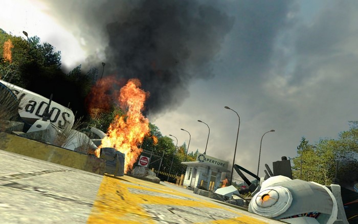 Portal GLaDOS wreckage with fire and Aperture Science building