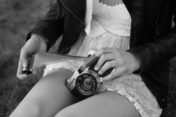 Woman holding film roll and Canon camera