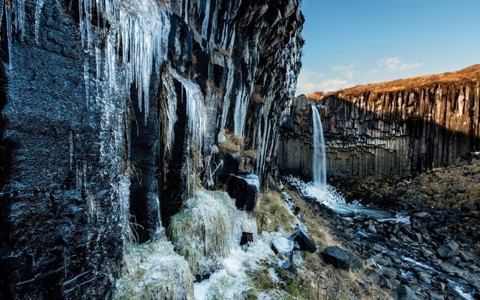 Frozen waterfall and basalt columns in Iceland