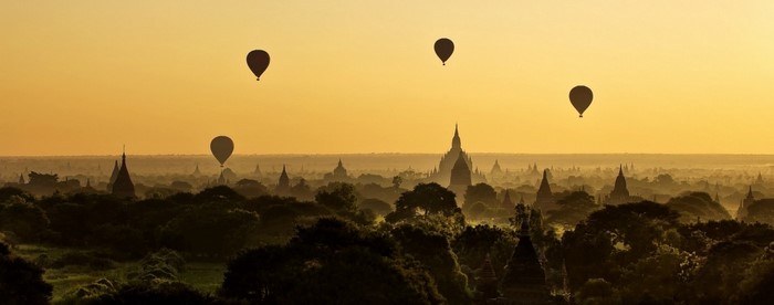 Hot air balloons over ancient temples at sunrise