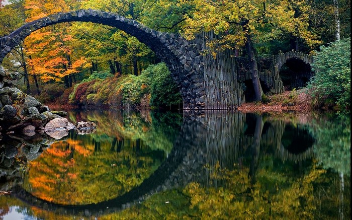 Rakotzbrücke bridge over a lake in autumn, Germany