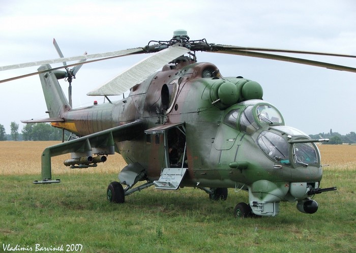 Mil Mi-24 Hind military helicopter on grassy field