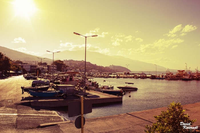 Boats docked in a harbor in Greece at sunset