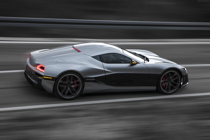 Silver Rimac Concept One driving on a road