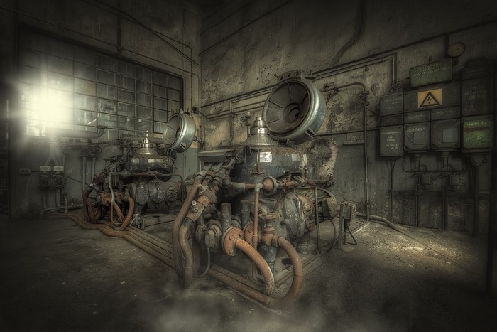 Abandoned industrial machinery in a dark factory