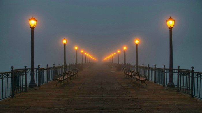 Pier with street lights in fog