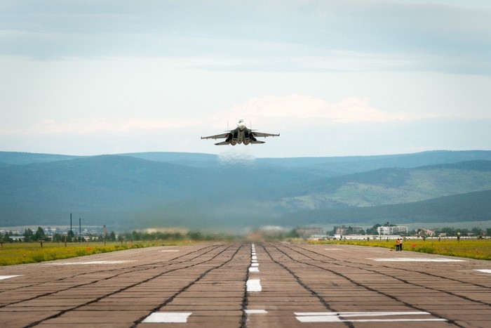 Sukhoi Su-30 fighter jet taking off from a runway