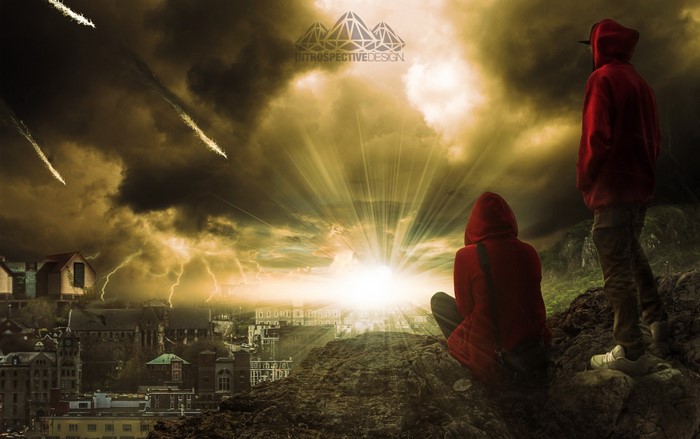 Two people in red hoodies watch a stormy sky over a city