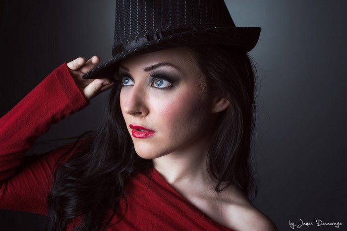 Woman in red top and fedora hat