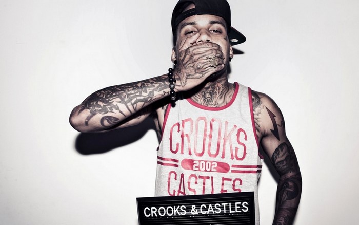 Man with tattoos and Crooks & Castles shirt