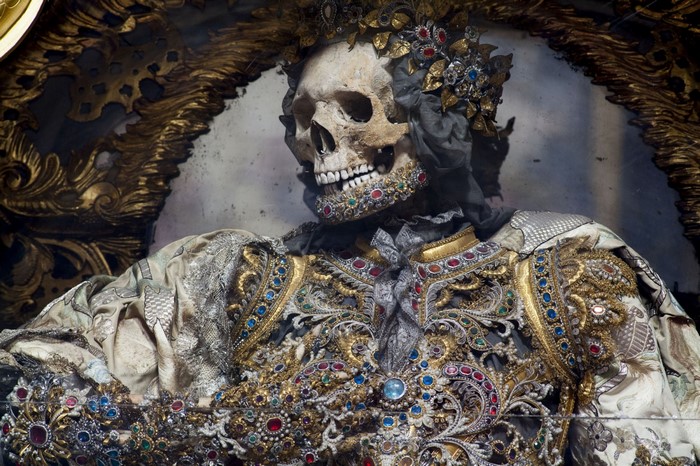 Skeleton adorned with jewels and ornate clothing