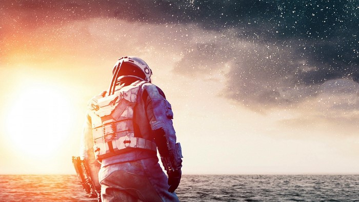 Astronaut looking at the sea and stars