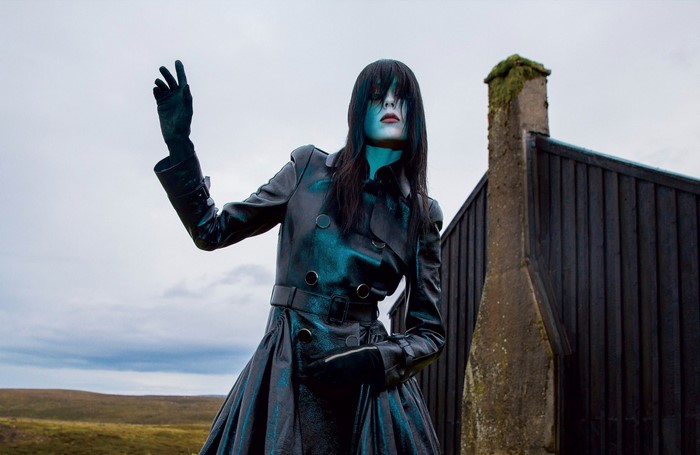 Model Edie Campbell in a dark trench coat