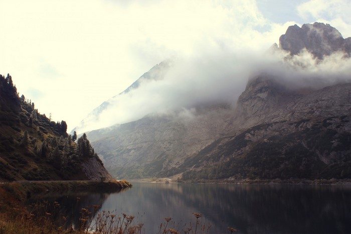 Misty mountains reflected in a lake