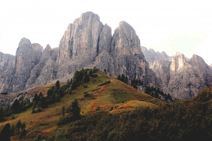 Rocky mountain range with green and brown hills