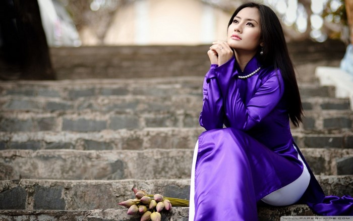 Elegant Woman in Purple Dress Sitting on Stone Stairs