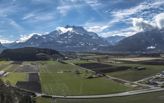 Aerial view of agricultural fields and snow-capped mountains