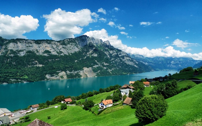 Mountain lake with village and green hills