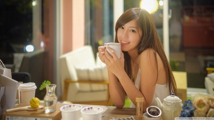 Asian woman holding a mug of coffee