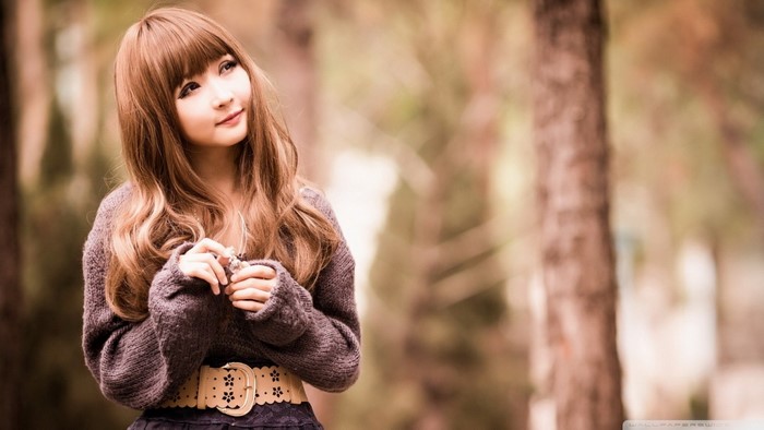 Young Asian woman with long brown hair in a sweater