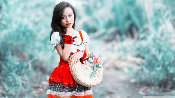 Asian woman in red and white dress holding a basket