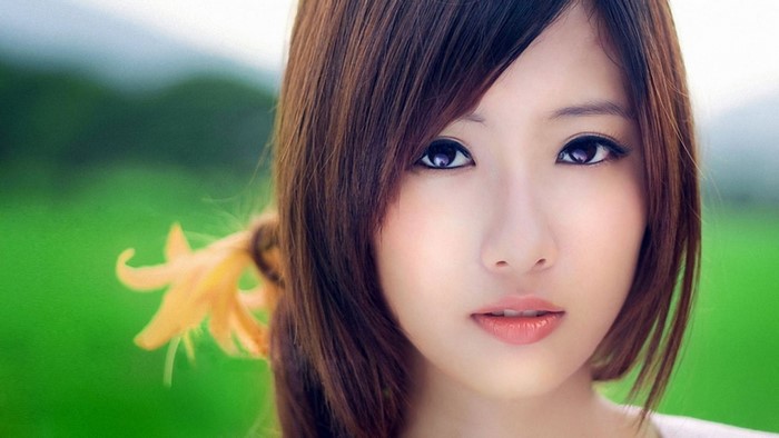 Close-up Portrait of Woman with Brown Hair and Flower