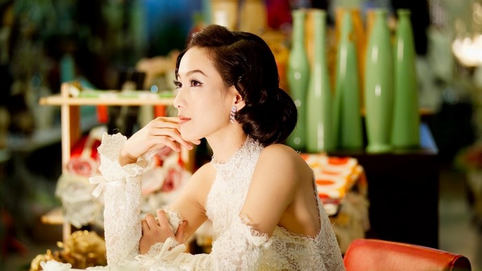 Woman in a white lace dress with elaborate sleeves