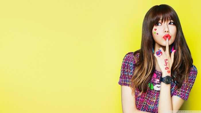Woman with colorful outfit and makeup on yellow background