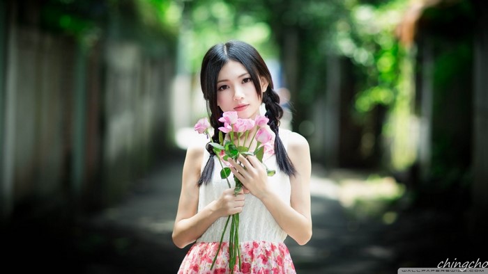 Young woman holding pink roses