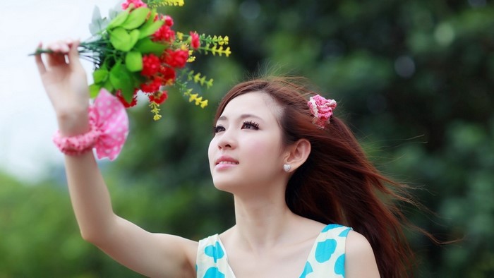 Young Asian woman holding a bouquet of flowers