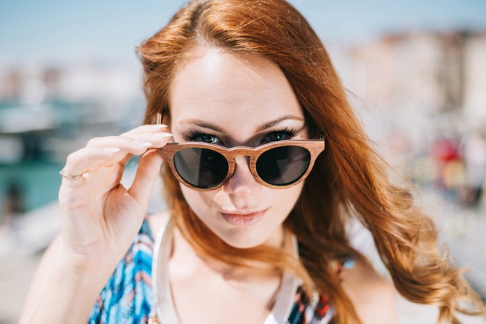 Woman with red hair wearing sunglasses