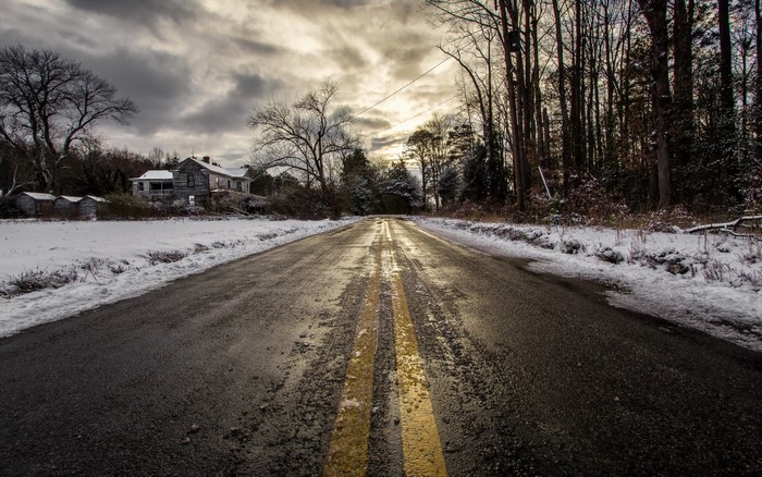 Abandoned house on a snowy road in winter