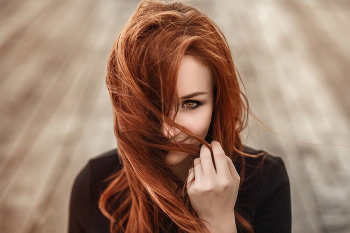 Redhead woman with long hair in portrait
