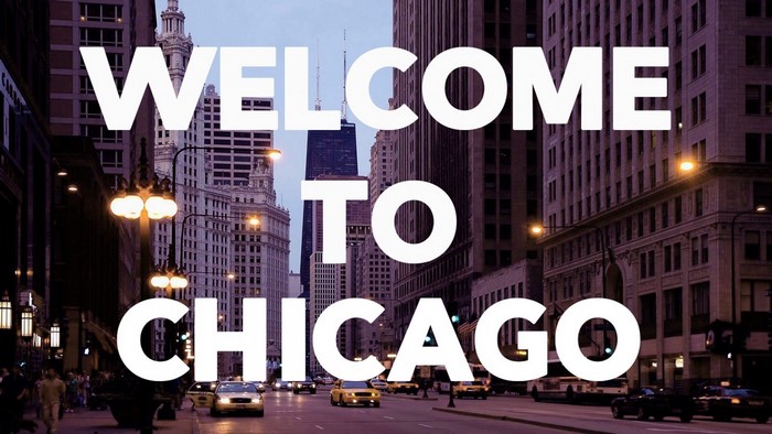 Welcome to Chicago text overlay on city street at night