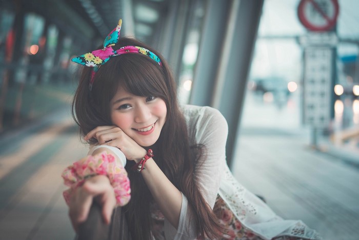Young Asian woman with floral headband and dress