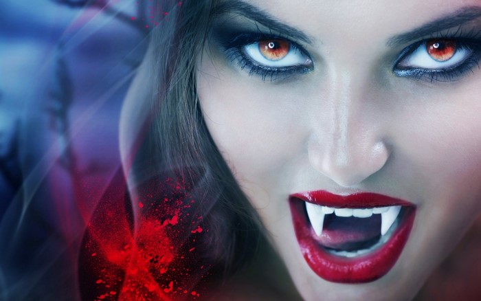Vampire woman with red eyes and fangs