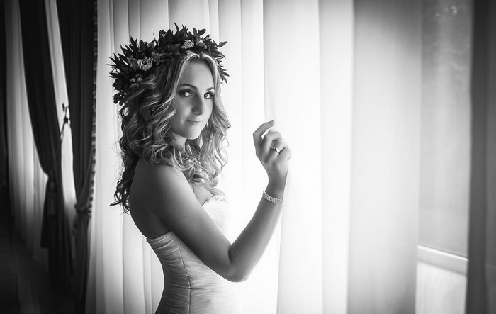 Bride with flower crown by window