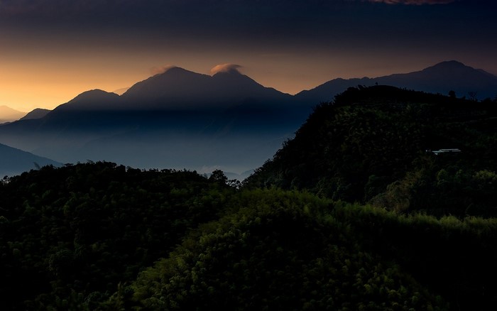 Mountains shrouded in mist at sunset