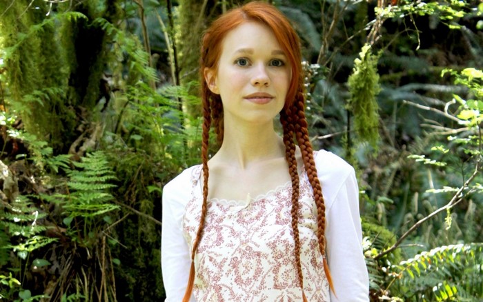 Redhead woman with braids in a forest