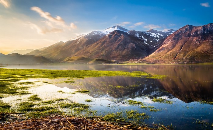 Serene Mountain Lake at Morning with Snowy Peaks