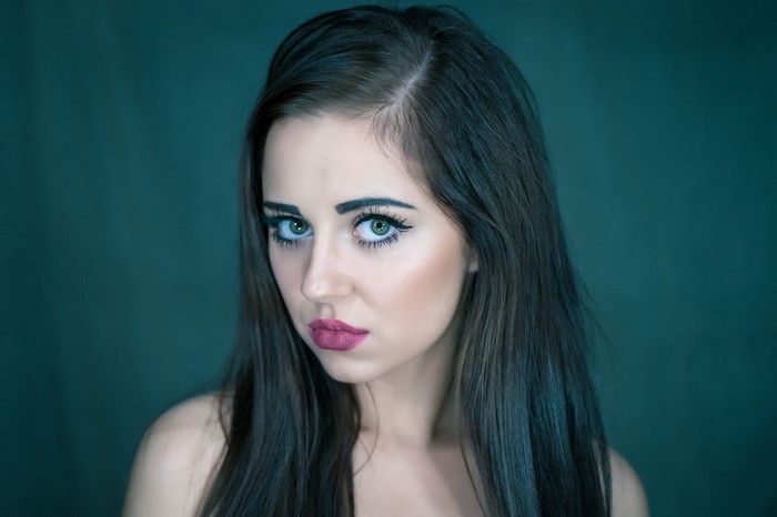 Woman with long dark hair and green eyes