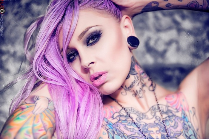 Woman with purple dyed hair and tattoos