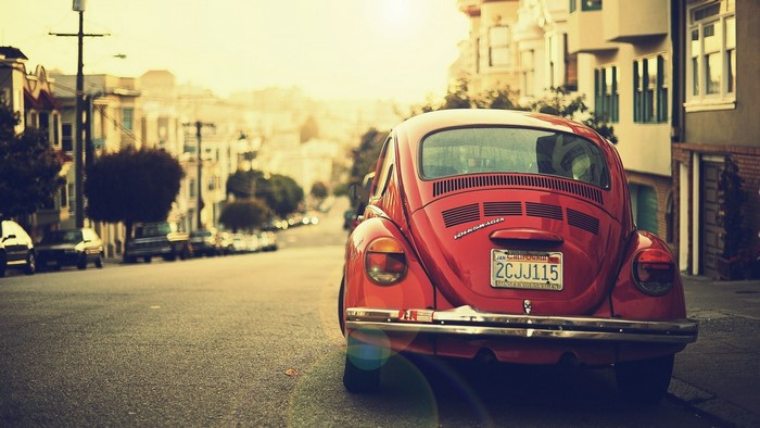 Red Volkswagen Beetle parked on a San Francisco street