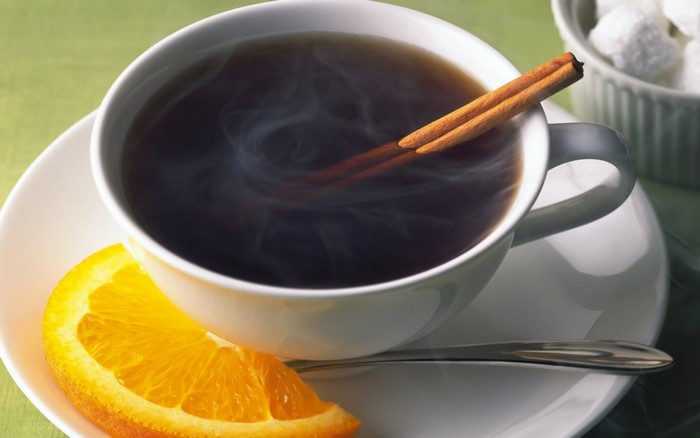 Hot coffee with cinnamon and orange slice