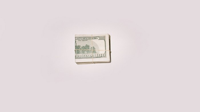 Stack of US Dollar Bills Tied with Rubber Band